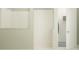 Contemporary shower with sleek white tiling and a glass partition, accompanied by an open doorway to a closet at 4765 Southern Valley Loop, Brooksville, FL 34601
