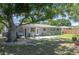 Expansive backyard featuring a patio, mature tree, and lush lawn, ideal for outdoor entertaining and relaxation at 4917 99Th N St, St Petersburg, FL 33708