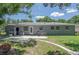 The home's backyard features a cozy patio and lush greenery, offering a serene outdoor space for relaxation and enjoyment at 4917 99Th N St, St Petersburg, FL 33708