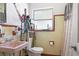 Retro bathroom with pink sink and tan tiled walls, offering a unique vintage charm at 4917 99Th N St, St Petersburg, FL 33708