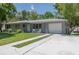 A charming single-story home with a freshly sealed driveway and well-manicured lawn at 4917 99Th N St, St Petersburg, FL 33708