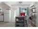 Bright kitchen featuring white appliances, an island, and a modern air conditioning unit at 4917 99Th N St, St Petersburg, FL 33708
