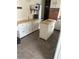 Well-organized kitchen featuring white cabinets, an island, and modern appliances at 4917 99Th N St, St Petersburg, FL 33708
