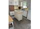 Compact kitchen with white cabinetry, an island and well maintained appliances at 4917 99Th N St, St Petersburg, FL 33708