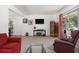 Cozy living room with comfortable seating, carpet flooring, and bright natural light at 4917 99Th N St, St Petersburg, FL 33708