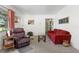 Inviting living room with plush seating, carpet, and a decorative table with vase at 4917 99Th N St, St Petersburg, FL 33708