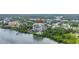Stunning aerial view of a high-rise condominium situated on the water with lush surrounding landscape at 500 N Osceola Ave # 211, Clearwater, FL 33755
