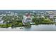Aerial view showcases building, waterfront location, and lush landscaping at 500 N Osceola Ave # 211, Clearwater, FL 33755