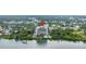 Aerial view shows building, lush surroundings and waterfront access at 500 N Osceola Ave # 211, Clearwater, FL 33755