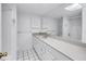 Bathroom with double vanity, wide mirror, and a tiled shower visible in the reflection at 500 N Osceola Ave # 211, Clearwater, FL 33755