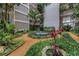 Serene courtyard with lush landscaping, a charming fountain, and inviting walkways for relaxation at 500 N Osceola Ave # 211, Clearwater, FL 33755