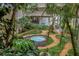 Lush courtyard with a tranquil fountain, vibrant greenery, and beautiful architectural views from all sides at 500 N Osceola Ave # 211, Clearwater, FL 33755