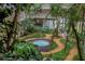 Lush courtyard with a tranquil fountain, vibrant greenery, and beautiful architectural views from all sides at 500 N Osceola Ave # 211, Clearwater, FL 33755