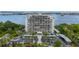 Condo exterior showcasing lush landscaping, driveway, covered parking, and elegant facade at 500 N Osceola Ave # 211, Clearwater, FL 33755