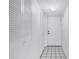 Hallway featuring tile floors, a door, and multiple storage closets at 500 N Osceola Ave # 211, Clearwater, FL 33755