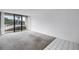 Bright living room with carpet flooring and large sliding glass doors to balcony at 500 N Osceola Ave # 211, Clearwater, FL 33755