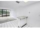 View of the living room showing access to the balcony and the kitchen area at 500 N Osceola Ave # 211, Clearwater, FL 33755