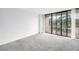 Empty living room with a balcony and large sliding glass doors at 500 N Osceola Ave # 211, Clearwater, FL 33755