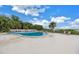 Inviting community pool surrounded by tropical greenery and lounge chairs provides relaxation at 500 N Osceola Ave # 211, Clearwater, FL 33755
