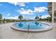 Community pool surrounded by comfortable lounge chairs and lush landscaping, perfect for relaxation at 500 N Osceola Ave # 211, Clearwater, FL 33755