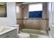 Updated bathroom featuring tiled walls, a bath tub, and a modern vanity for comfort and style at 5016 S 86Th St, Tampa, FL 33619