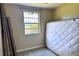 Bedroom showing window with bars and a mattress, ready for a new tenant at 5016 S 86Th St, Tampa, FL 33619