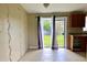 The dining area has tiled floors and natural light from a sliding glass door to the backyard at 5016 S 86Th St, Tampa, FL 33619