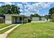 Modest single-story home featuring a covered carport and a well-maintained front lawn at 5016 S 86Th St, Tampa, FL 33619
