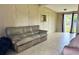 A spacious living room with tile flooring, neutral walls, and sliding glass doors at 5016 S 86Th St, Tampa, FL 33619