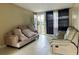 Cozy living room with tile flooring and a comfortable seating area bathed in natural light at 5016 S 86Th St, Tampa, FL 33619