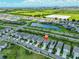 Aerial view of a well-manicured neighborhood with ponds, green fields, and modern homes under a blue sky with clouds at 5438 Summer Sunset Dr, Apollo Beach, FL 33572