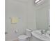 Powder room featuring a sleek sink, toilet, and towel bar, perfect for guests at 5438 Summer Sunset Dr, Apollo Beach, FL 33572