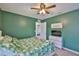 This bedroom offers an attractive color scheme, ceiling fan, and a tropical-themed bed set at 5438 Summer Sunset Dr, Apollo Beach, FL 33572