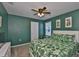 This bedroom offers an attractive color scheme, tropical-themed bed set, and a ceiling fan at 5438 Summer Sunset Dr, Apollo Beach, FL 33572