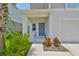 Cozy front porch with seating and a well-maintained garden, creating a welcoming entrance at 5438 Summer Sunset Dr, Apollo Beach, FL 33572