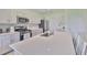 Modern kitchen featuring stainless steel appliances, white cabinets, and a functional center island at 5438 Summer Sunset Dr, Apollo Beach, FL 33572