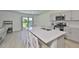 Stylish kitchen with stainless steel appliances, a large center island, and ample counter space at 5438 Summer Sunset Dr, Apollo Beach, FL 33572