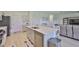 Open-concept kitchen featuring stainless steel appliances and a center island with seating at 5438 Summer Sunset Dr, Apollo Beach, FL 33572