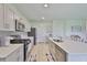 Bright kitchen with white cabinets, stainless steel appliances, and a spacious center island at 5438 Summer Sunset Dr, Apollo Beach, FL 33572