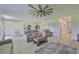 Inviting living area with neutral decor, wood floors, and an open layout connecting to the kitchen at 5438 Summer Sunset Dr, Apollo Beach, FL 33572
