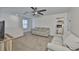 Spacious living room with a ceiling fan, plush couches, tv and neutral-colored carpet at 5438 Summer Sunset Dr, Apollo Beach, FL 33572