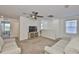 Bright living room with a ceiling fan, plush couches and neutral-colored carpet at 5438 Summer Sunset Dr, Apollo Beach, FL 33572