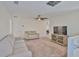 Cozy living room with neutral colors, a ceiling fan, and plush carpeting at 5438 Summer Sunset Dr, Apollo Beach, FL 33572