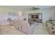 Comfortable living room with plush seating, a decorative ceiling fan, and a large entertainment center at 5438 Summer Sunset Dr, Apollo Beach, FL 33572