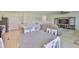 Open living area featuring wood floors, neutral decor, and seamless transition to the kitchen at 5438 Summer Sunset Dr, Apollo Beach, FL 33572