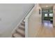 Carpeted staircase leading to a bright, open living area with hardwood floors at 5438 Summer Sunset Dr, Apollo Beach, FL 33572