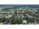 Wide aerial view shows a suburban neighborhood dotted with trees and houses with varied roof colors at 5918 Beaconpark St, Lithia, FL 33547