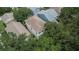This aerial view showcases the neighborhood's layout with tree coverage and well-maintained homes and roofs at 5918 Beaconpark St, Lithia, FL 33547