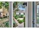View of a well-manicured backyard, showcasing a separate dwelling with lush landscaping and a brick pathway at 5918 Beaconpark St, Lithia, FL 33547