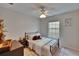 Well-lit bedroom with neutral tones, a ceiling fan and decor at 5918 Beaconpark St, Lithia, FL 33547